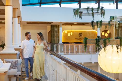 a man and a woman walking down a staircase at AluaSoul Costa Adeje - Adults Only in Adeje