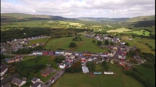 an aerial view of a village in the hills at Sheepviewhouse Leo in Kilgarvan