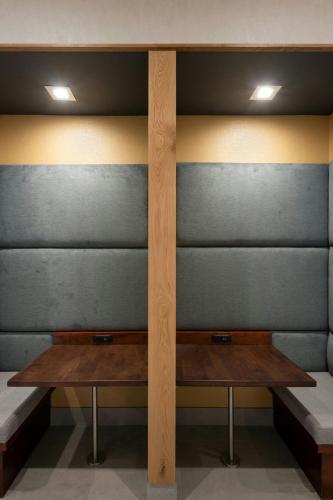 two wooden benches in a room with gray walls at Residence Inn By Marriott Philadelphia Bala Cynwyd in Bala-Cynwyd