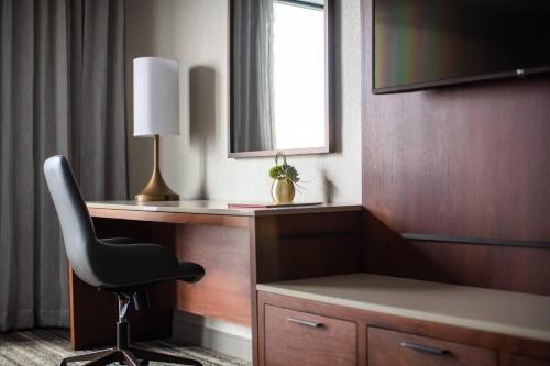 a room with a desk with a chair and a mirror at Kansas City Marriott Downtown in Kansas City