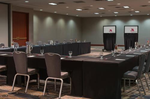 a row of tables in a room with chairs and tablesktop at Kansas City Marriott Downtown in Kansas City