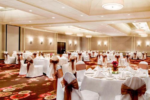 a banquet hall with white tables and chairs in it at Sheraton Cavalier Calgary Hotel in Calgary