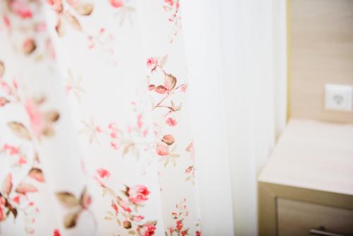 a bedroom with a curtain with flowers on it at Santa Rosa Hotel & Beach in Alexandroupoli