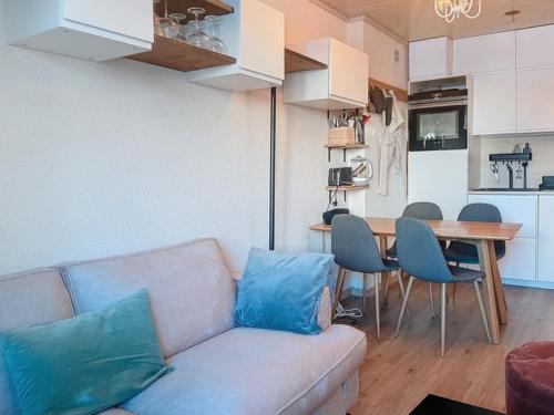 un salon avec un canapé et une table avec des chaises dans l'établissement Charmant 2 pièces à Val d'Isère, 4 pers, proche centre, TV, WiFi - FR-1-518-164, à Val dʼIsère