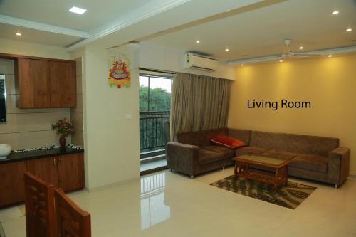 a living room with a couch and a table at Asset Chrisaballe in Kottayam