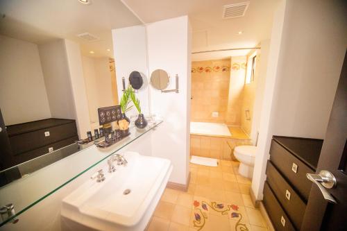 a bathroom with a sink and a toilet at Movich Casa del Alferez in Cali