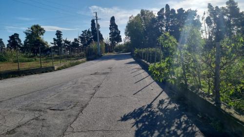 an empty road with a fence on the side at Taormina Roby Casa Vacanze in Giardini Naxos