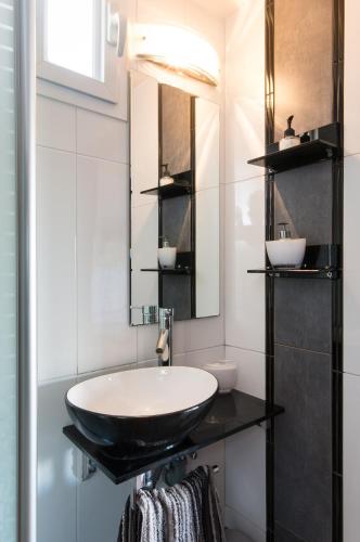a bathroom with a black sink and a mirror at Lovely studio on the Carmel Mt in Haifa