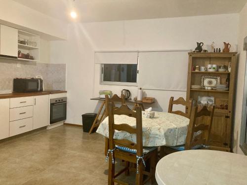 a kitchen with a table and chairs in a room at La Perla in Punta Colorada