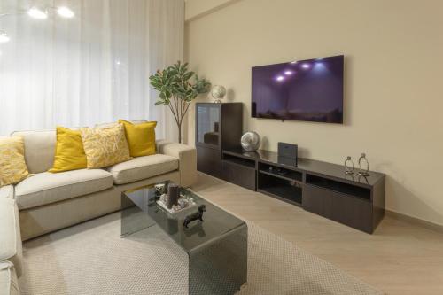a living room with a couch and a flat screen tv at Anastasia Comfort at the Vatican with Balcony in Rome