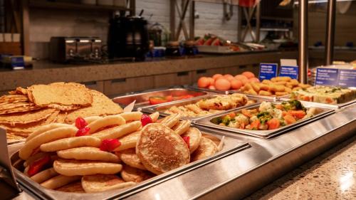 a buffet line with many different types of food at Wellton Riga Hotel & SPA in Rīga