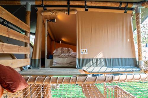 an inside view of a bed in a tent at Glamping Rhederlaagse Meren in Lathum