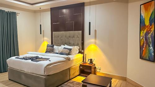 a bedroom with a bed in a room at Tribu Hotels in Enugu