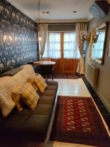 a living room with a couch and a table at Daiches Braes Brunstane Portobello in Edinburgh