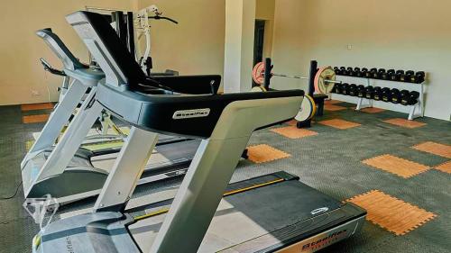 a room with a gym with a treadmill at Tribu Hotels in Enugu