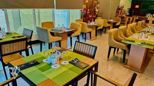 a dining room with tables and chairs in a restaurant at Tribu Hotels in Enugu
