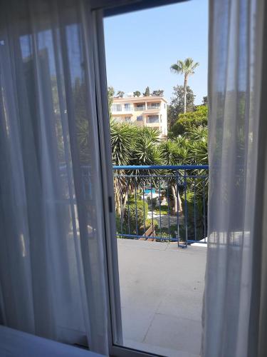 an open window with a view of a balcony at H&O Elegant Maisonette in Paradise Garden in Paphos