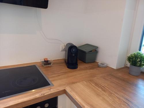 a kitchen counter with a black appliance on a wooden counter top at Bergzauber Ofterschwang in Ofterschwang