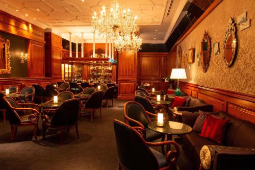 a restaurant with couches and tables and a chandelier at The Westin Osaka in Osaka