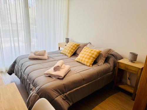 a bed with towels on it in a room at Premium Studio, Confort in La Plata