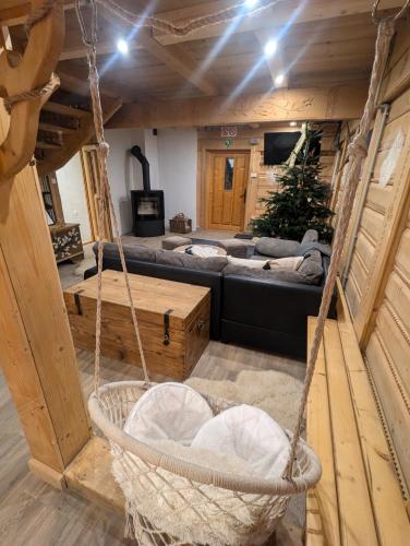 a room with a couch and a swing at U Leona in Gorlice