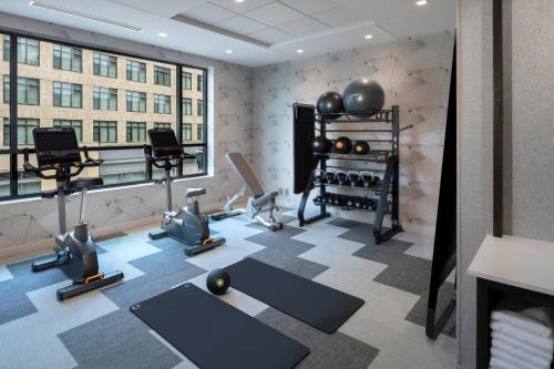 a fitness room with exercise equipment and a large window at TownePlace Suites by Marriott Boston Medford in Medford