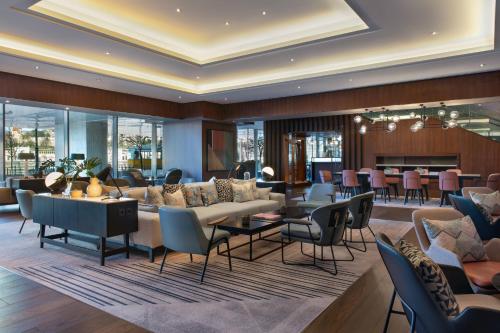 a living room with couches and tables and chairs at Budapest Marriott Hotel in Budapest