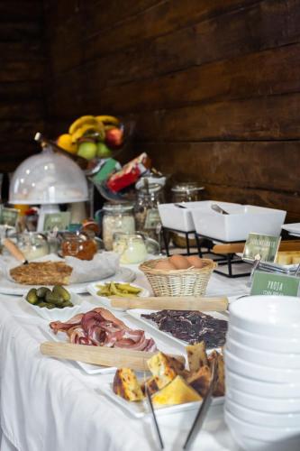 a white table with food on top of it at Kežman Mountain Houses in Kopaonik