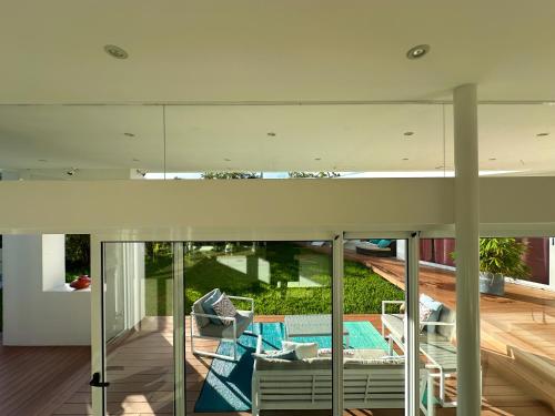 an open living room with a view of the backyard at Ocean View Villa 2min to beach - Casa Cantini in Montezuma