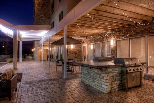 an outdoor bar with a grill on a patio at TownePlace Suites by Marriott St. Louis Chesterfield in Chesterfield