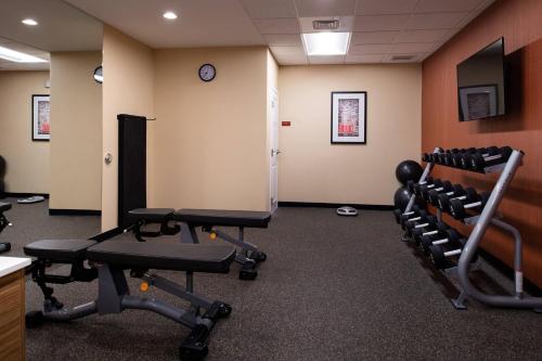 a gym with chairs and a clock on the wall at TownePlace Suites by Marriott St. Louis Chesterfield in Chesterfield