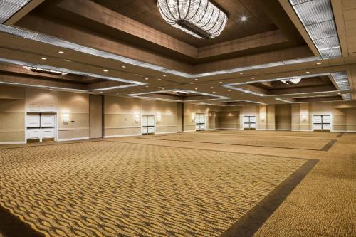 an empty ballroom with a large room with a large floor at Sheraton Charlotte Airport in Charlotte