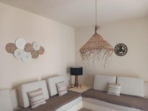 a living room with a couch and a clock at Beach Villa ,Lagoon ,Estoril - Sol y MAR in Sal Rei
