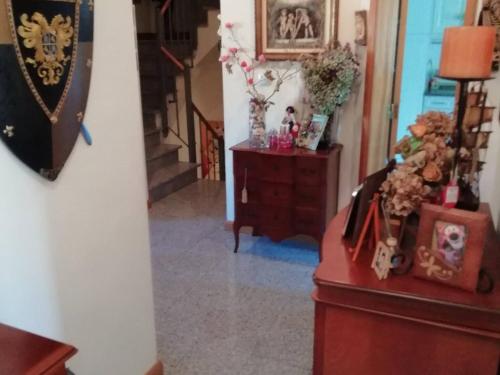 a hallway with a staircase and a dresser with flowers at Global Guests in Sintra