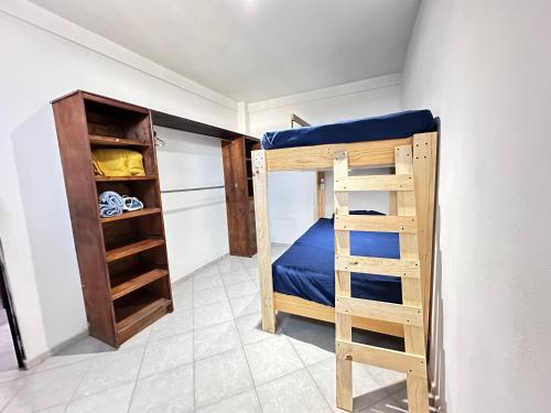 a bedroom with a bunk bed and a closet at Mini Suite 14 Cerca De Aut MEX QRO in Cuautitlán Izcalli