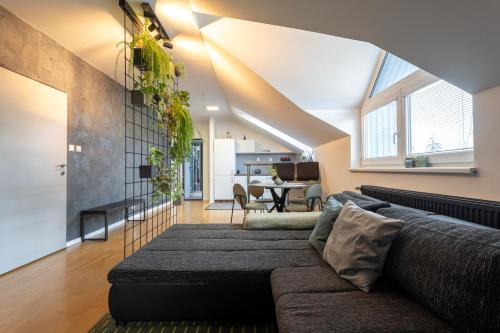 a living room with a couch and a table at Urban Bloom apartments by Booky in Liptovský Mikuláš