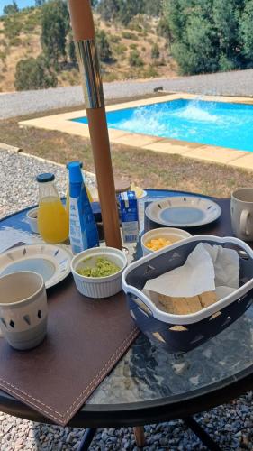 a table with a tray of food on top of it at Grado8punto8 Glamping Valle de Los Artistas in Lolol
