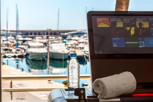 a bottle of water sitting on top of a laptop computer at Riviera Marriott Hotel La Porte De Monaco in Cap d'Ail