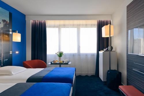 a hotel room with a bed and a table at Mercure Nice Centre Notre Dame in Nice