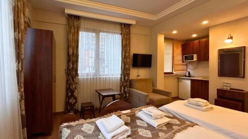 a hotel room with two beds and a kitchen at Capricorn by Otantik Suites in Istanbul