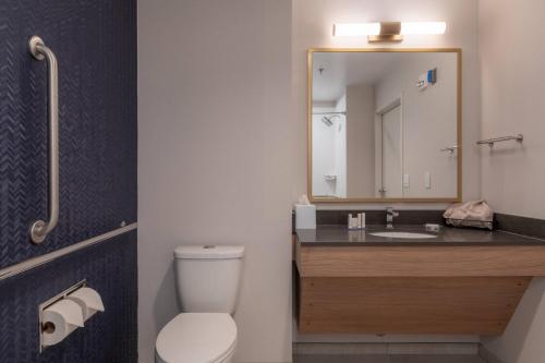 a bathroom with a toilet and a sink with a mirror at Fairfield by Marriott Inn & Suites Revelstoke in Revelstoke