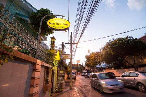 a sign for a sushi shop on a city street at Samsen Sam Place in Bangkok