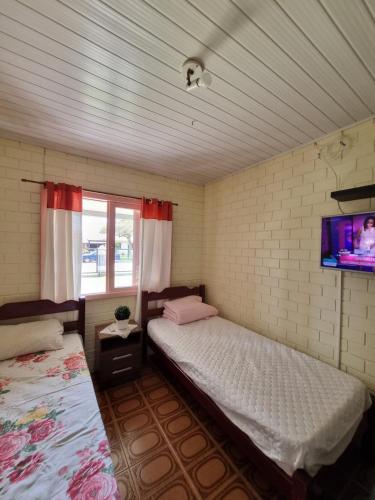 Postel nebo postele na pokoji v ubytování Casa com piscina em Arroio do Sal