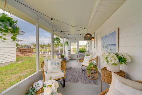 a porch with wicker chairs and flowers on it at Screened Patio and Fish On-Site! Punta Gorda Gem in Punta Gorda