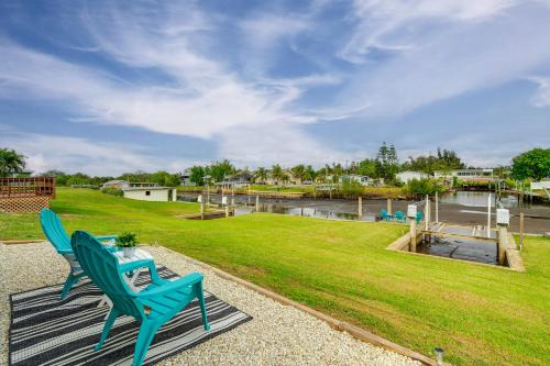 a couple of blue chairs and a table and a river at Screened Patio and Fish On-Site! Punta Gorda Gem in Punta Gorda