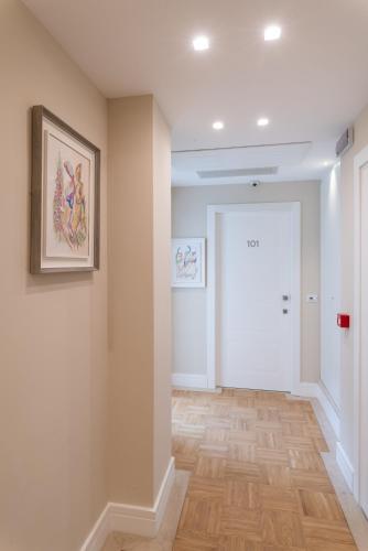 a room with a hallway with a door and wooden floors at Palazzo Bibbi - Rooms to Live in Reggio Calabria