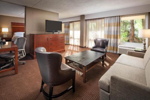 a hotel room with a couch and a table and a bed at Sheraton Agoura Hills Hotel in Agoura Hills