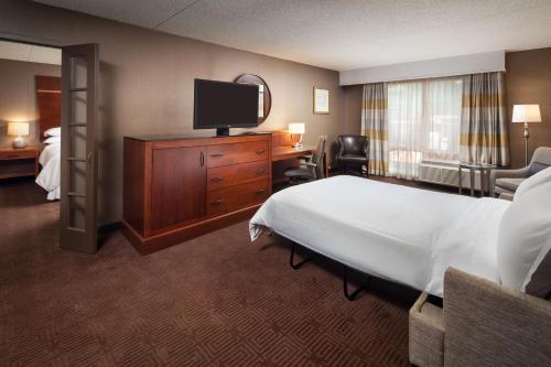 a hotel room with a bed and a flat screen tv at Sheraton Agoura Hills Hotel in Agoura Hills