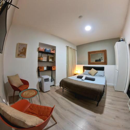 a bedroom with a bed and a chair at Hidden Gem Hideaway Retreat in Central Town Area with AC in Gibraltar