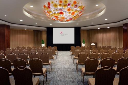 a conference room with chairs and a projection screen at Marriott Orlando Airport Lakeside in Orlando